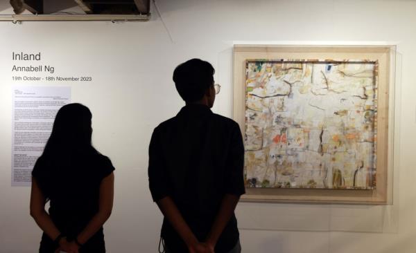 Visitors taking a look at Ng's work titled 'Resilience'. It carries nuanced symbolism, subtly referencing the diverse facets of our environment. Photo: The Star/Chan Tak Kong