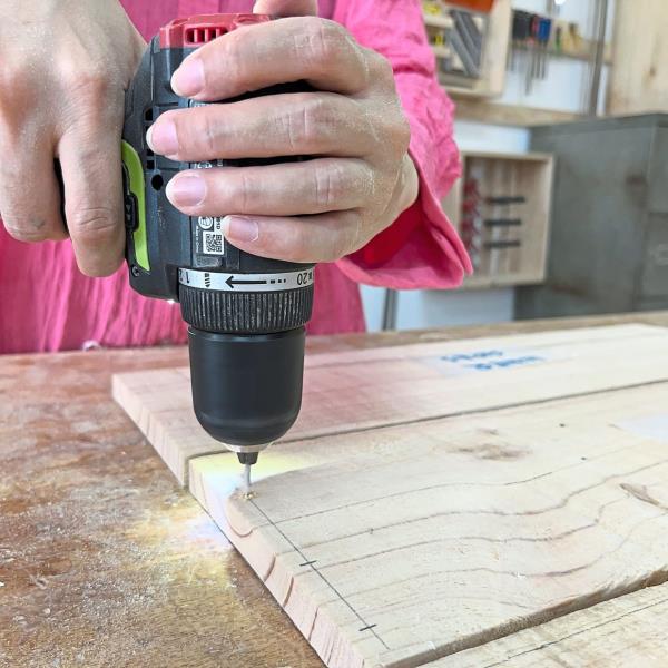 Grab a drill driver if you have one. Make holes at the marked spots. If you don’t have a drill driver, no worries – pallet wood is soft enough to hammer without any holes.