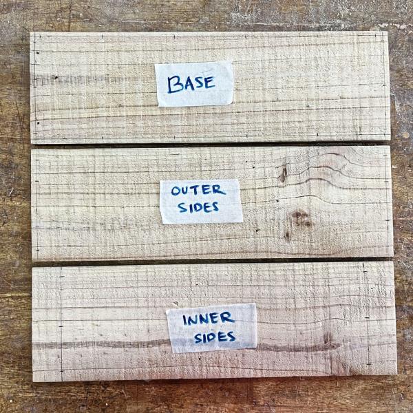 Next, mark three of the 15cm x 50cm boards. Measure all sides for the ba<em></em>se. As for the two side pieces, mark on both the inside and outside surfaces.