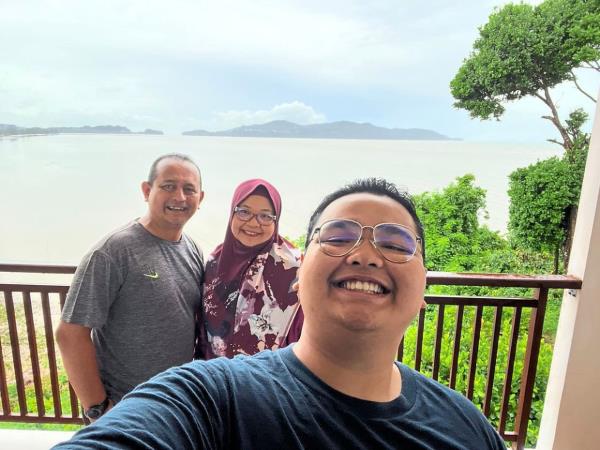 The writer (left) with his wife and son at a hotel in Pak Bara.