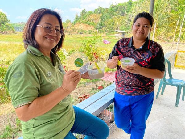 Darisa (left) and Tumin enjoying their bubur lambuk.