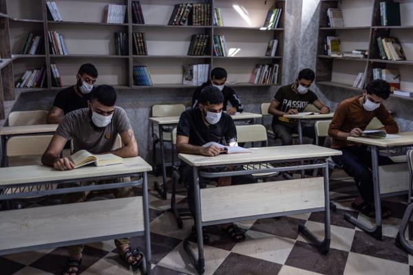 Priso<em></em>ners sit in the library of the Military Police prison in Aleppo, which is designated for those who were charged with drug-related crimes.