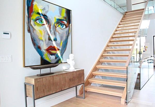 A striking piece of art is paired with minimal elements to add a wow factor upon entry.