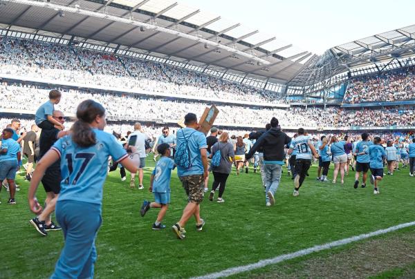 City fans invade the pitch. — Reuters