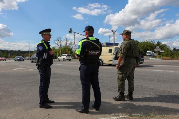 Police officers at a checkpoint in a road in Belgorod