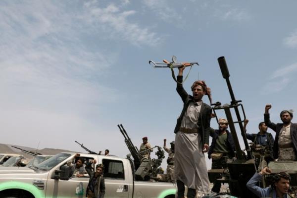 Houthi fighters shout slogans during a gathering of Houthi loyalists on the outskirts of Sanaa