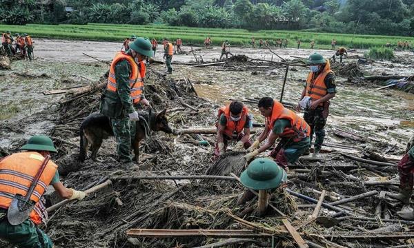  Rescue officials sift through debris at the site of a landslide in the remote mountainous village of Lang Nu, in northern Vietnam’s Lao Cai province on September 12. — AFP 